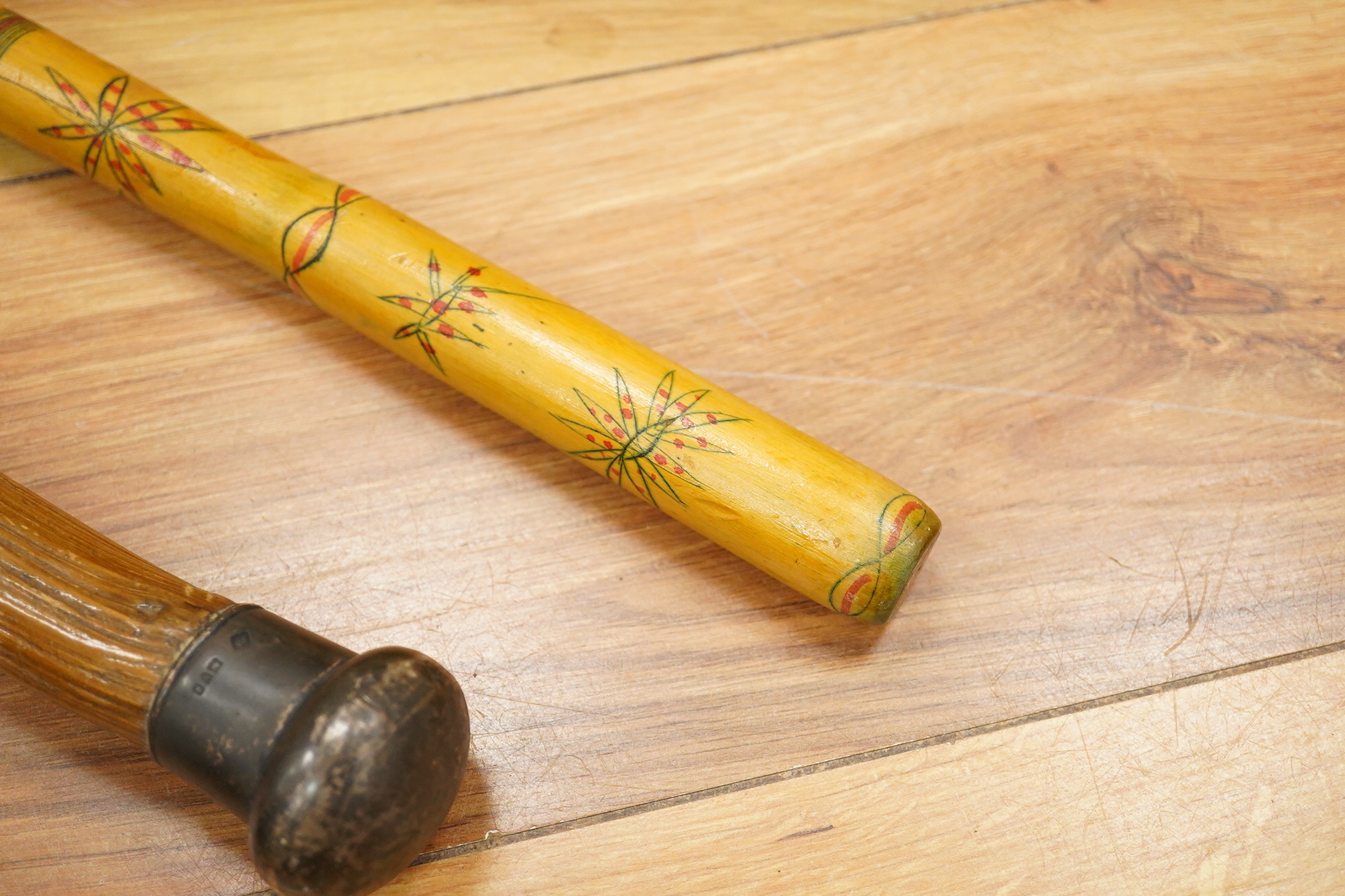 Five walking sticks including horn and a silver topped walking sticks and a carved topped walking stick with concealed chamber containing a metal tube - 93cm long. (5).